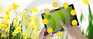 Gardening and flowers e-commerce concept, online shopping on digital tablet, hand pointing and touch screen with green empty icons