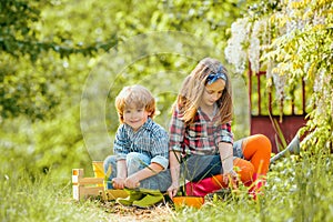 Gardening with a kids. Children enjoy in farm. Kids portrait on farmland. Spring gardening routine. Happy kids on summer