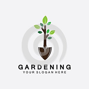 Gardening logo with shovel icon and tree with green leaves logo template photo