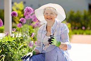 Senior woman with garden pruner and flowers photo
