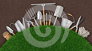 Gardening tool equipment. Top view on ground soil background and Lawn green grass with copy space. Online shopping commerce,