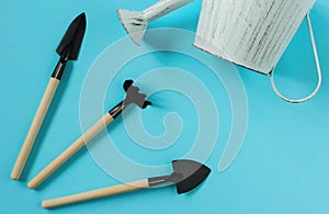 Gardening tools on blue background. Spring garden works concept. Top view. Copy space