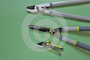 Gardening Tools. shears, secateurs on a green background. Garden Plants Pruning Tool.Gardening and farming tools