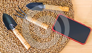 Gardening tools smartphone top view on the table gardening hobby cocnept photo