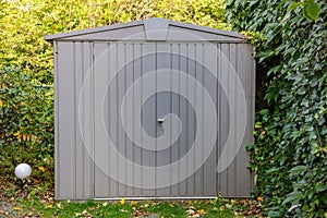 Gardening tools storage shed in the house backyard