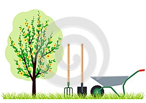 Gardening tree wheelbarrow spade and pitchfork