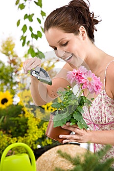 Gardening - woman holding flower pot and shovel