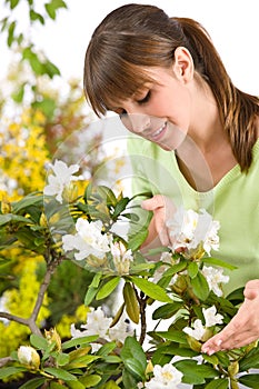 Gardening - woman with Rhododendron flower