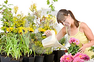 Gardening - woman with watering can pouring water