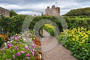 Gardens and Castle of Mey with colorful flowers on a cloudy day
