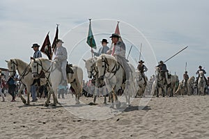 Gardians and camargue horses on the beach
