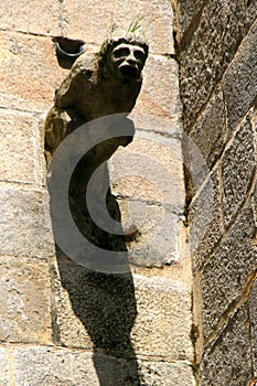 A gargoyle decorates the facade of a church (France)
