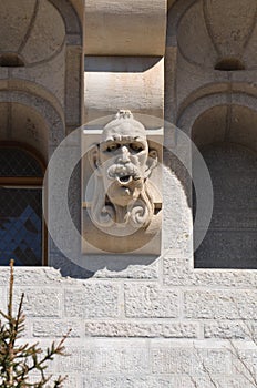 Gargoyle grimaces as building decoration