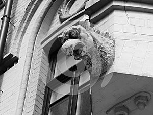 A gargoyle on the wall of the building in the centre of Moscow