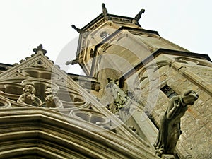 Gargoyles in a historic tower beside the entry of the Carcassone cathedral.