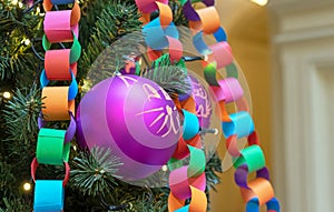 Garland-chain made of colored paper on Christmas tree. Christmas and New Year's decor