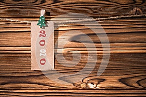 Garland with cute little kraft paper stickers hanging on a rope on wooden clothespins. 2020. Christmas tree. Rustic Christmas