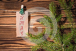 Garland with cute little kraft paper stickers hanging on a rope on wooden clothespins. Xmas. Santa Claus.  Rustic Christmas