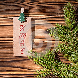 Garland with cute little kraft paper stickers hanging on a rope on wooden clothespins. Xmas. Santa Claus.  Rustic Christmas