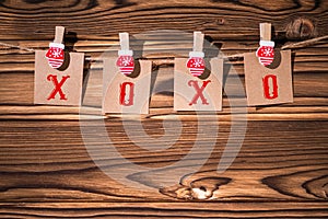 Garland with cute little kraft paper stickers hanging on a rope on wooden clothespins. Xo - xo -xo. Santa Claus.  Rustic Christmas