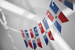 A garland of Dominicana national flags on an abstract blurred background