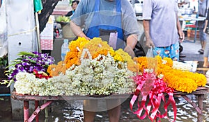 Garland flowers selling in table shop in Thai walking market