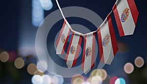 A garland of French Polynesia national flags on an abstract blurred background