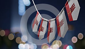 A garland of Gibraltar national flags on an abstract blurred background