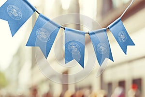 A garland of International Intellectual Property Organization national flags on an abstract blurred background