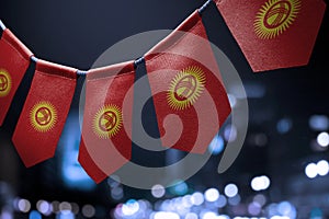 A garland of Kirghizia national flags on an abstract blurred background