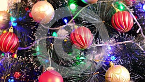 Garland lights on a ball-decorated Christmas tree