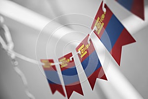 A garland of Mongolia national flags on an abstract blurred background photo