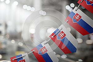 A garland of Slovakia national flags on an abstract blurred background