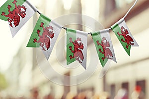 A garland of Wales national flags on an abstract blurred background