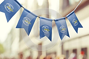 A garland of World Health Organization WHO national flags on an abstract blurred background