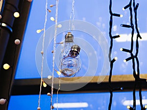 Garlands are hanging on the window. multi-colored light bulbs garlands on a window close-up. New year garland