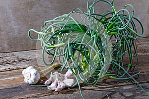 Garlic arrows. A bunch of greens on the table. Vegetable healthy vitamin food. Green stalks seedlings for salad and