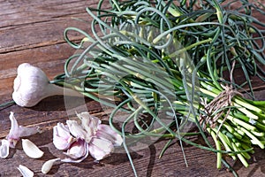 Garlic arrows. A bunch of greens on the table. Vegetable healthy vitamin food. Green stalks seedlings for salad and