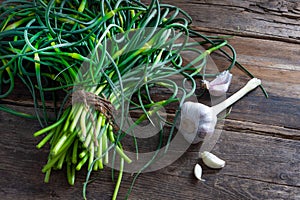 Garlic arrows. A bunch of greens on the table. Vegetable healthy vitamin food. Green stalks seedlings for salad and