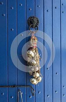 Garlic braid on a blue door