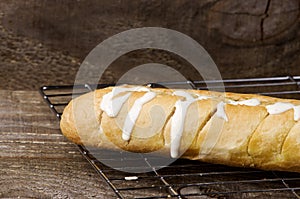 Garlic bread on cooling rack. Wooden background.