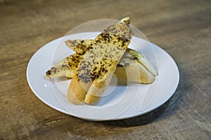 Garlic Bread served hot on a round plate.