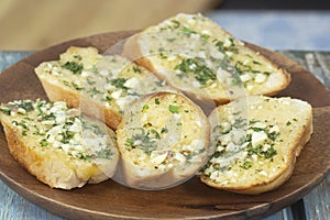 Garlic bread on the wooden plate