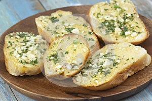 Garlic bread on the wooden plate