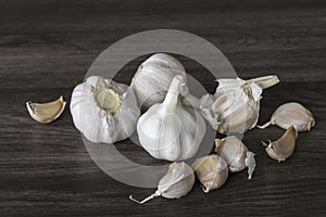 Garlic bulbs on wooden table.