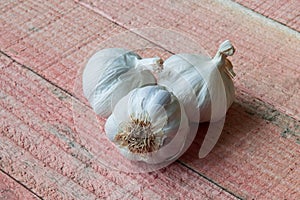 Garlic bulbs close up on the red pine wood table top