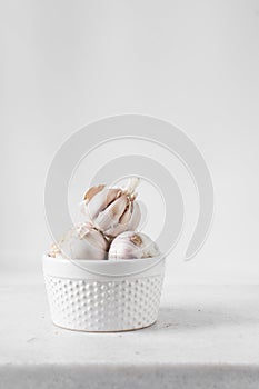Garlic bulbs on a hobnail white ramekin