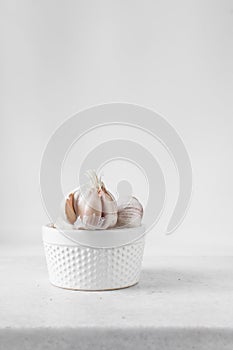 Garlic bulbs on a hobnail white ramekin