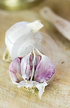 Garlic bulbs on wooden chopping board