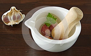 Garlic and celery leaf ready for mashing in a mortar and pestle